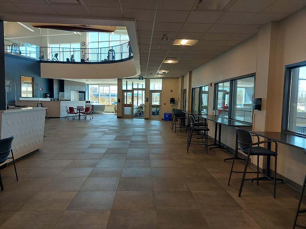a main area of the YMCA with tables and chairs