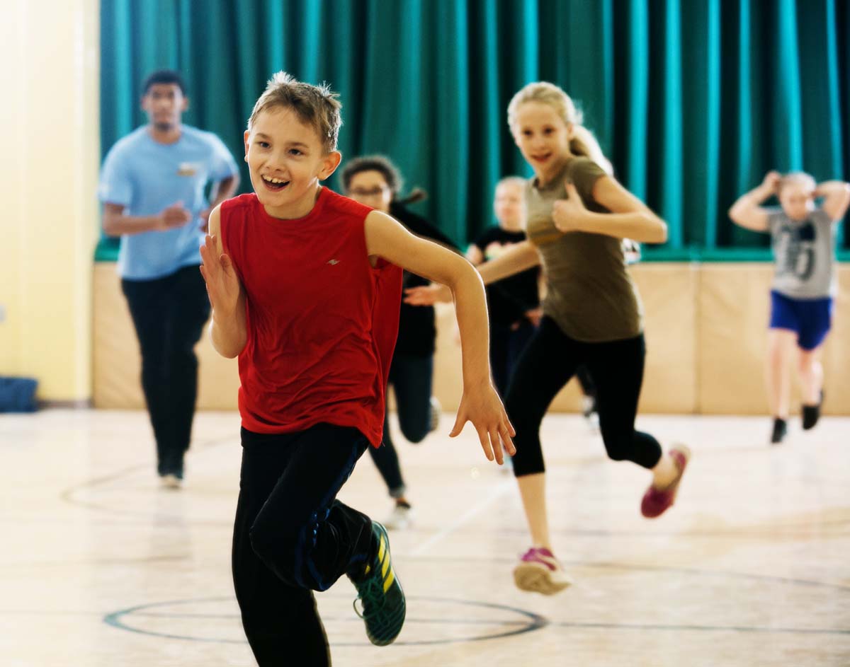 Children running in a gym.