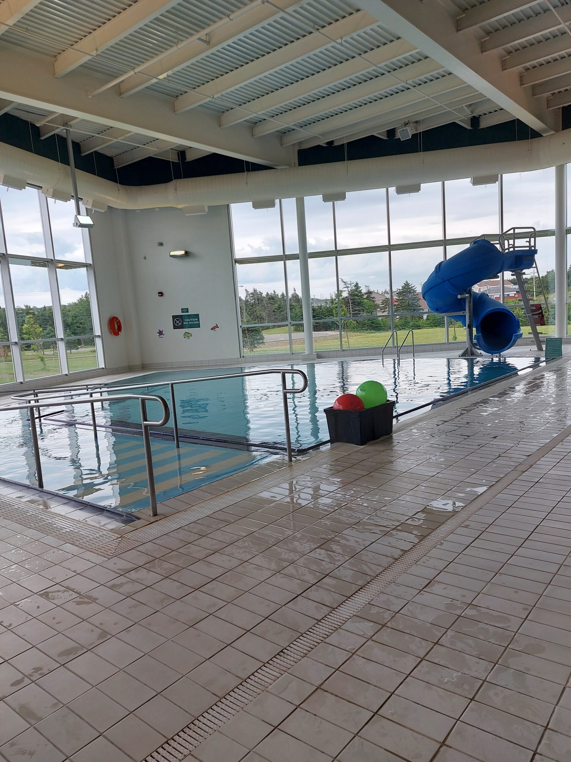 a wide angle view of a pool with a slide and ramp