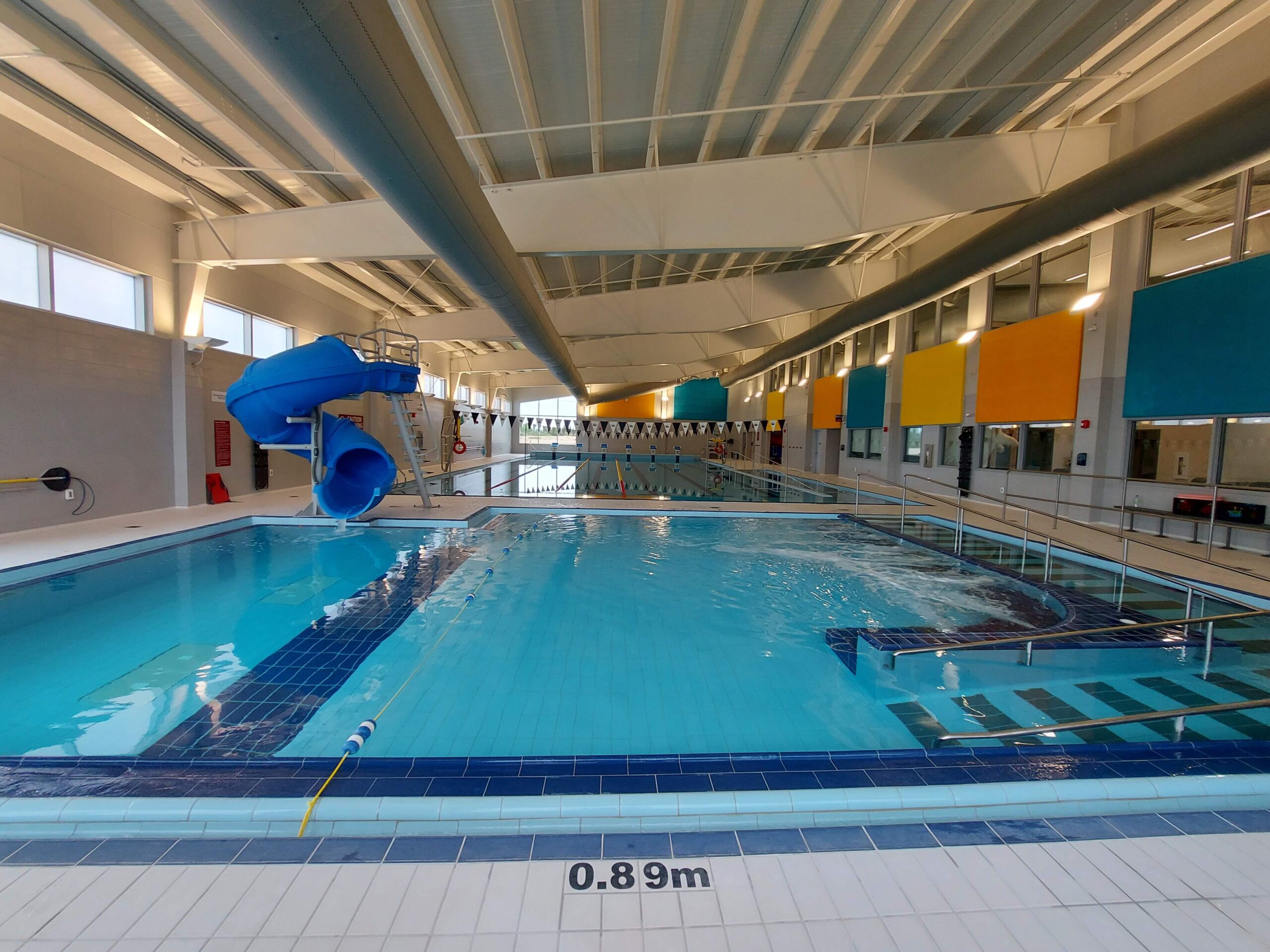 a wide angle view of a swimming pool with a ramp and slide