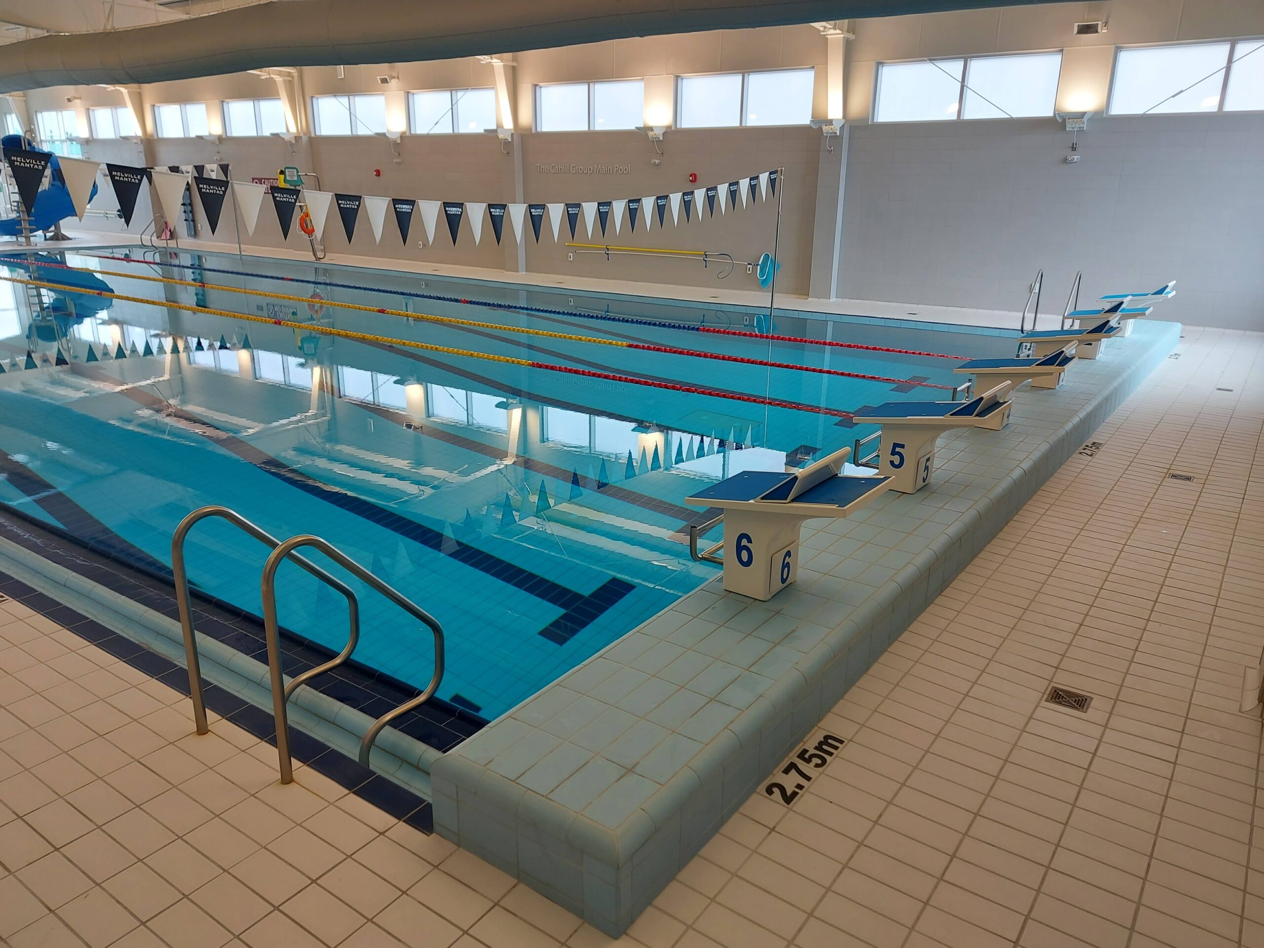 a view of the deep end of a pool, showing the diving blocks