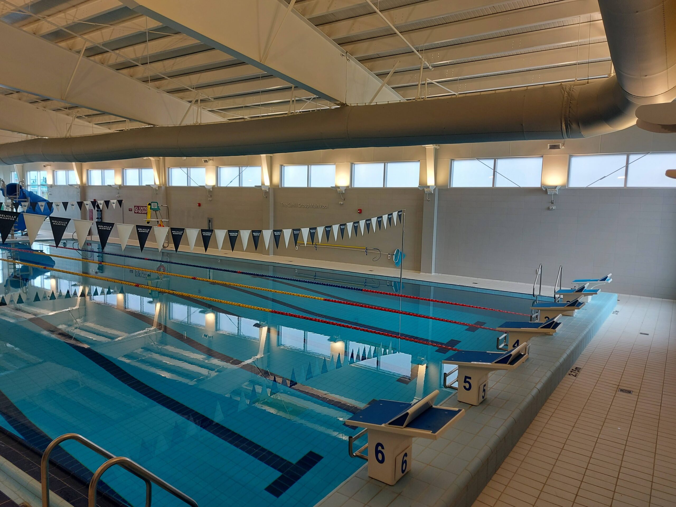 a view of the deep end of a pool with diving blocks