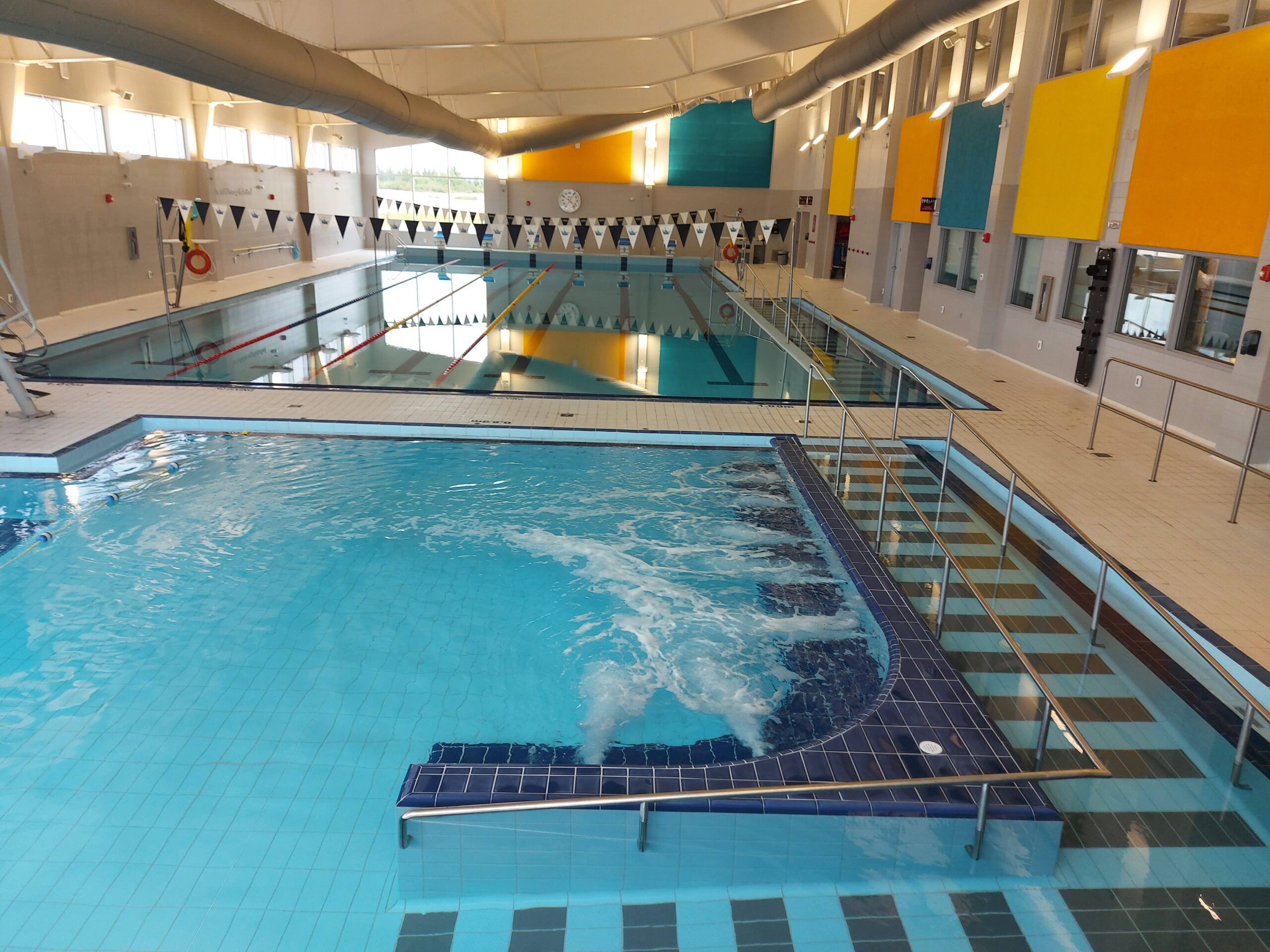 a high-up angle of two swimming pools