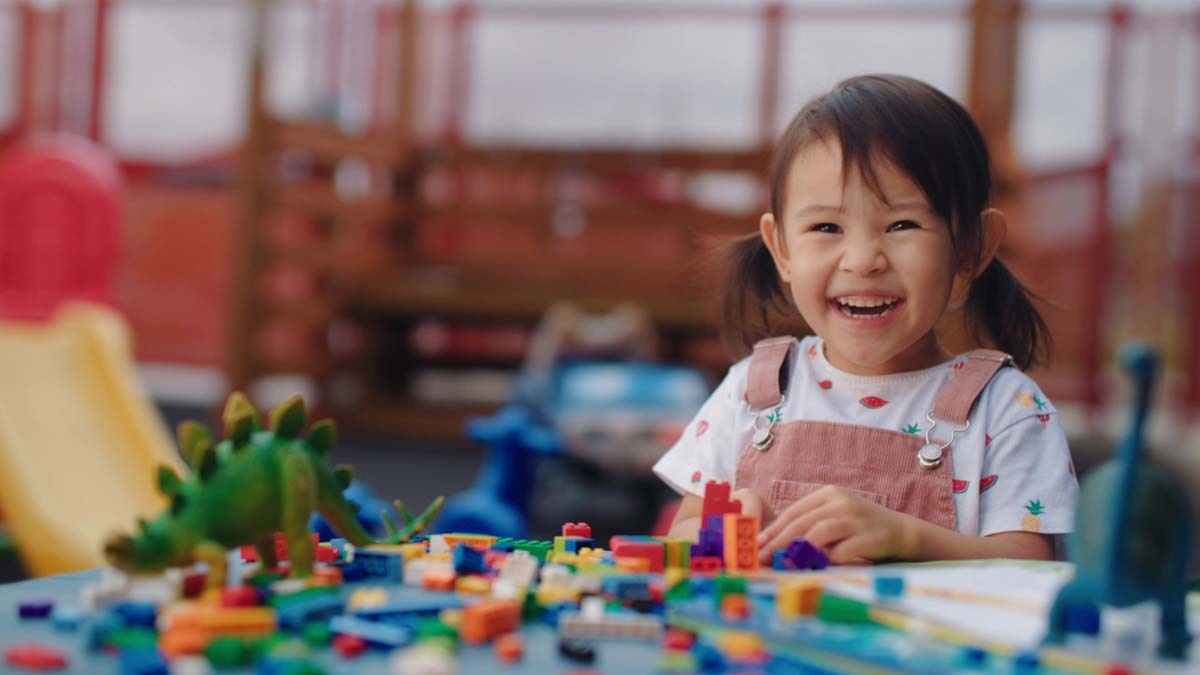 a child playing with toys and smiling
