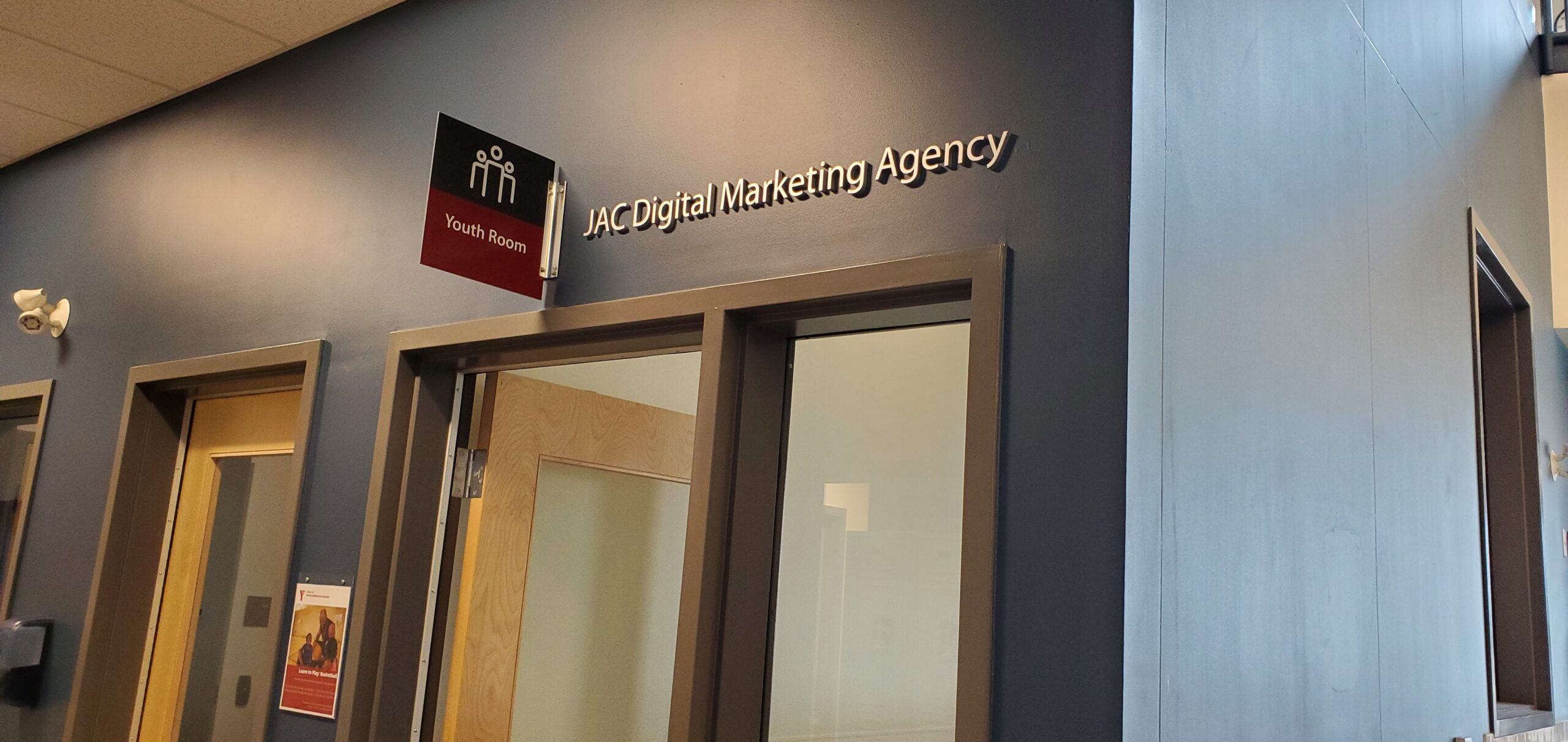 a sign above a doorway that says "Youth Room" with "JAC Digital Marketing Agency" next to it